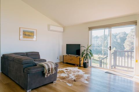 The lounge with TV and doors out to the deck